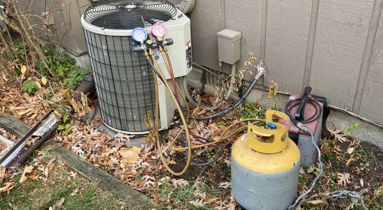 Mechanical Extremes technician handling refrigerant during an AC service call